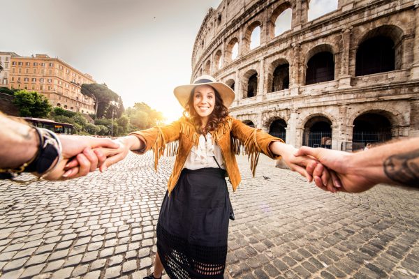 Toerist geniet van het Colosseum in Rome, Italië, met de zonsondergang op de achtergrond. Perfect voor last minute citytrips.